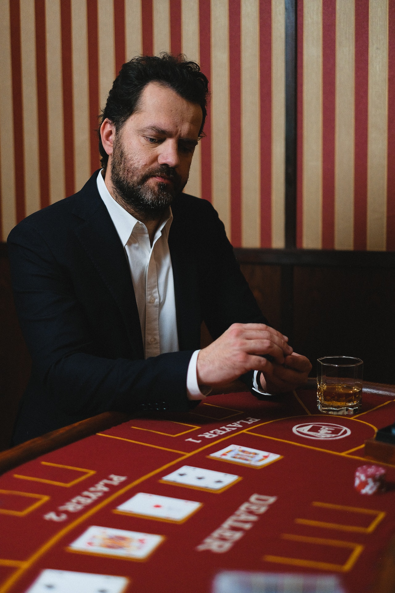 Man with a suit playing blackjack