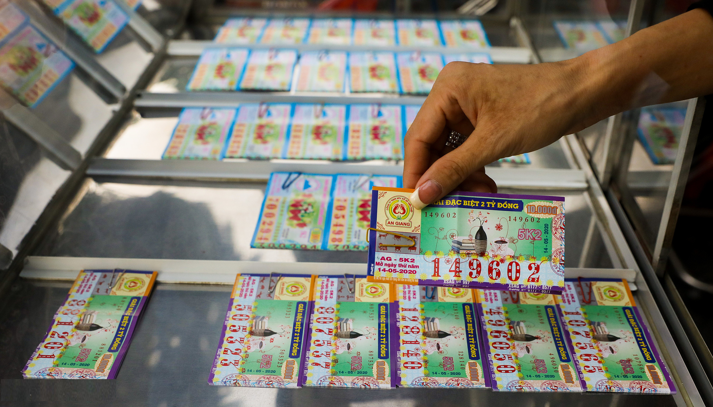 A man picking a lottery ticket of xổ số miền nam